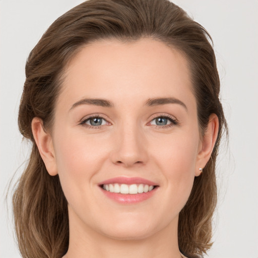 Joyful white young-adult female with long  brown hair and grey eyes