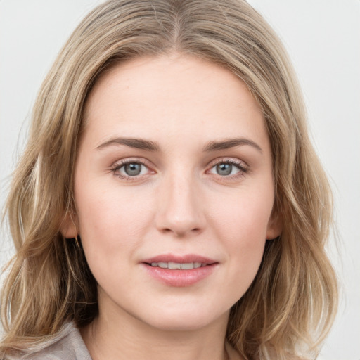 Joyful white young-adult female with medium  brown hair and green eyes