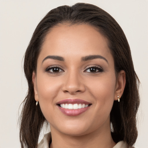 Joyful white young-adult female with long  brown hair and brown eyes