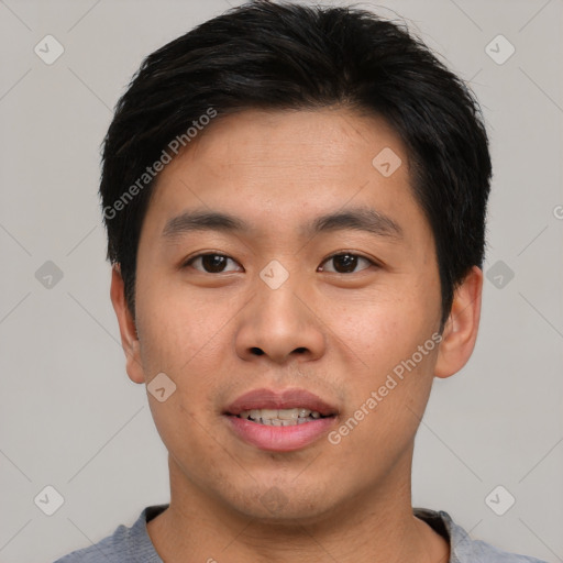 Joyful asian young-adult male with short  black hair and brown eyes