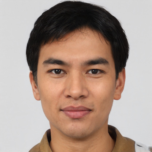 Joyful asian young-adult male with short  black hair and brown eyes