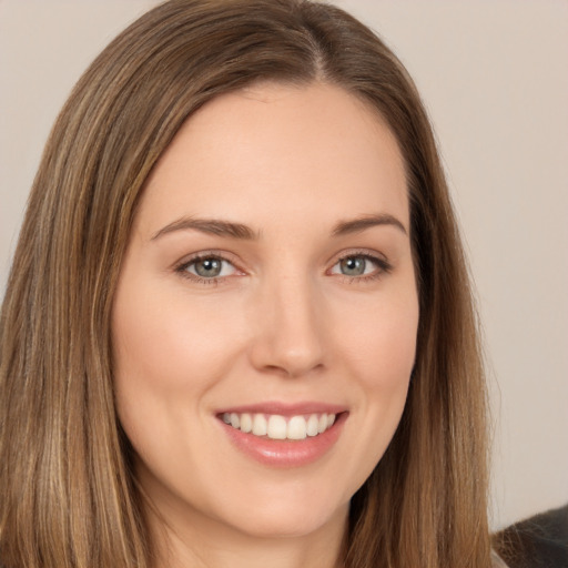 Joyful white young-adult female with long  brown hair and brown eyes