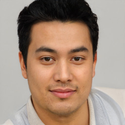 Joyful asian young-adult male with short  brown hair and brown eyes