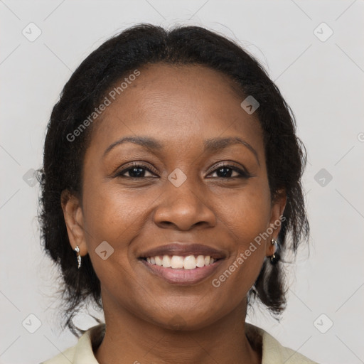 Joyful black adult female with medium  brown hair and brown eyes