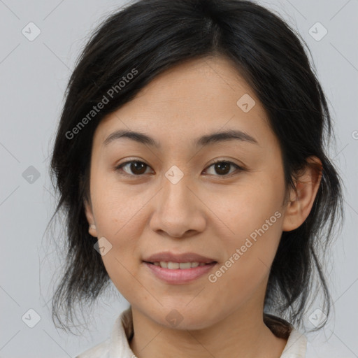 Joyful asian adult female with medium  brown hair and brown eyes