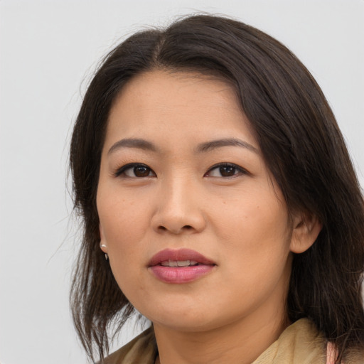 Joyful asian young-adult female with medium  brown hair and brown eyes