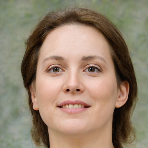 Joyful white young-adult female with medium  brown hair and green eyes