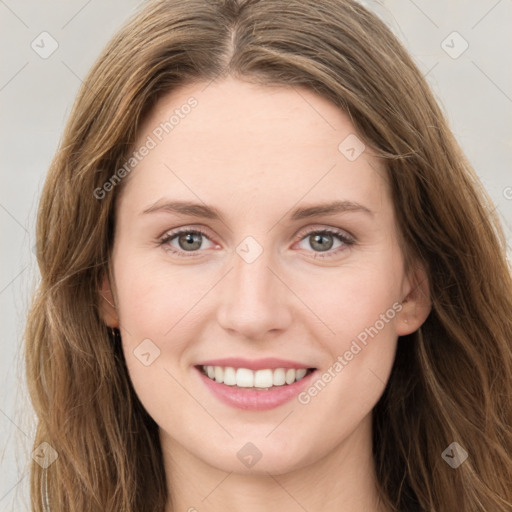 Joyful white young-adult female with long  brown hair and green eyes