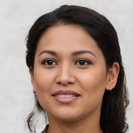 Joyful latino young-adult female with long  brown hair and brown eyes