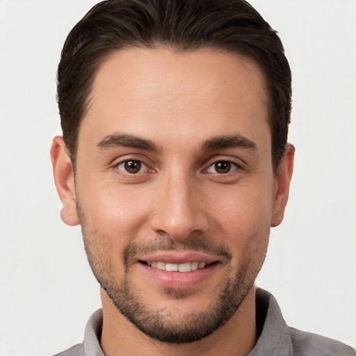 Joyful white young-adult male with short  brown hair and brown eyes