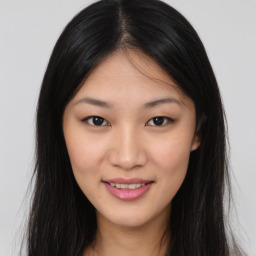 Joyful asian young-adult female with long  brown hair and brown eyes