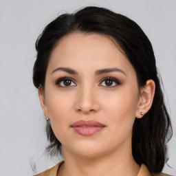 Joyful latino young-adult female with medium  brown hair and brown eyes