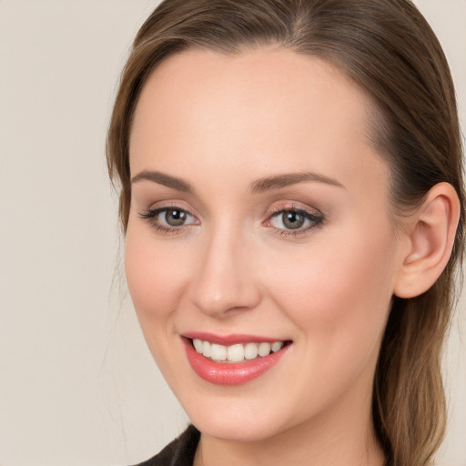 Joyful white young-adult female with long  brown hair and grey eyes