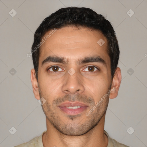 Joyful white young-adult male with short  black hair and brown eyes