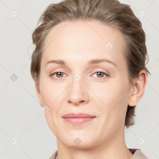 Joyful white adult female with medium  brown hair and grey eyes