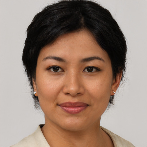 Joyful asian adult female with medium  black hair and brown eyes