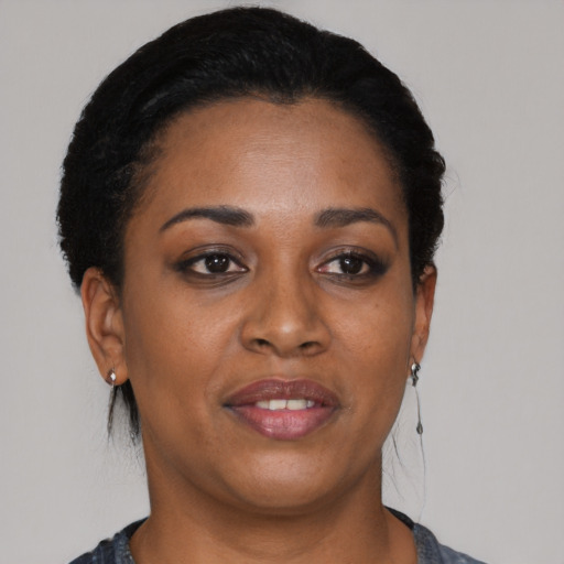 Joyful black young-adult female with short  black hair and brown eyes