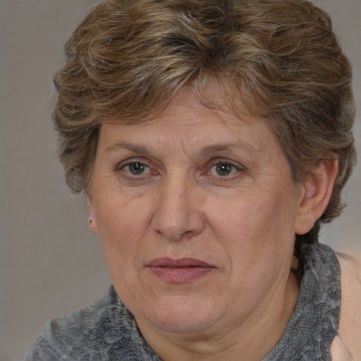 Joyful white middle-aged female with medium  brown hair and brown eyes