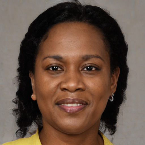 Joyful black young-adult female with medium  brown hair and brown eyes