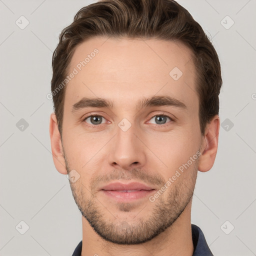 Joyful white young-adult male with short  brown hair and grey eyes