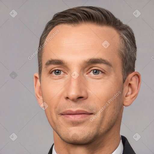 Joyful white adult male with short  brown hair and brown eyes