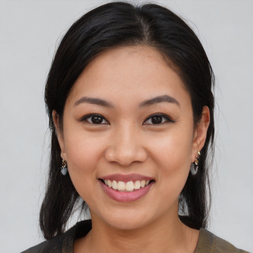Joyful asian young-adult female with medium  black hair and brown eyes