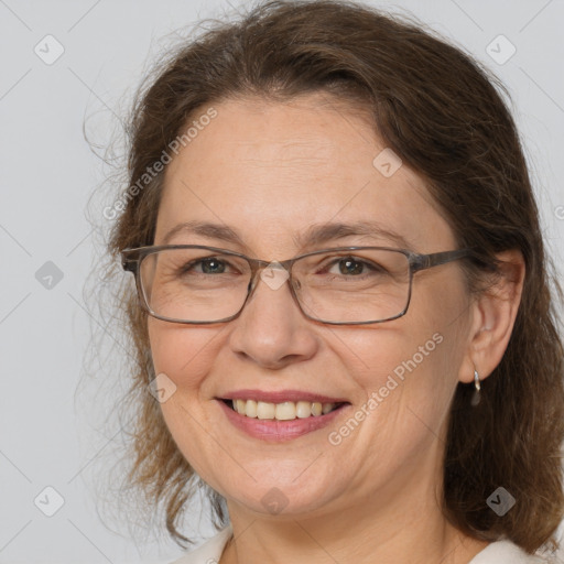 Joyful white adult female with medium  brown hair and grey eyes