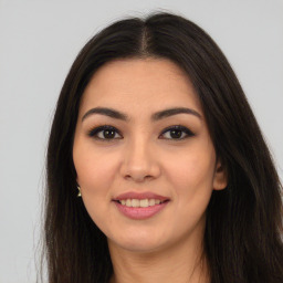 Joyful latino young-adult female with long  brown hair and brown eyes