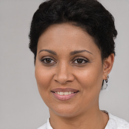 Joyful latino young-adult female with short  brown hair and brown eyes