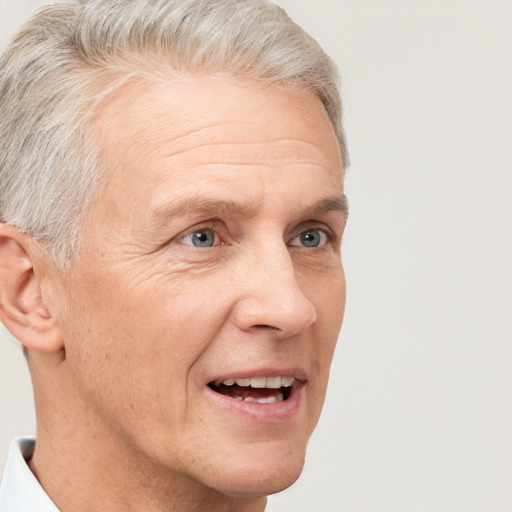 Joyful white middle-aged male with short  gray hair and grey eyes