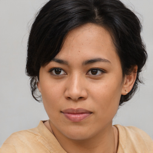 Joyful asian young-adult female with medium  brown hair and brown eyes