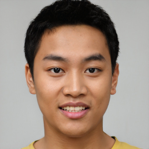 Joyful asian young-adult male with short  black hair and brown eyes