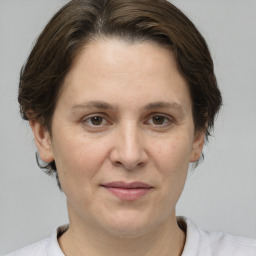 Joyful white adult female with medium  brown hair and brown eyes