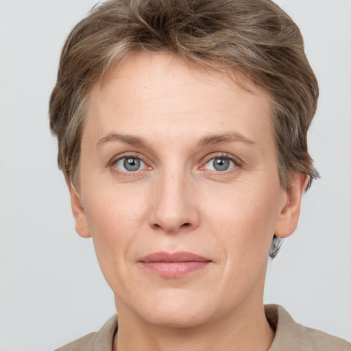 Joyful white adult female with short  brown hair and grey eyes