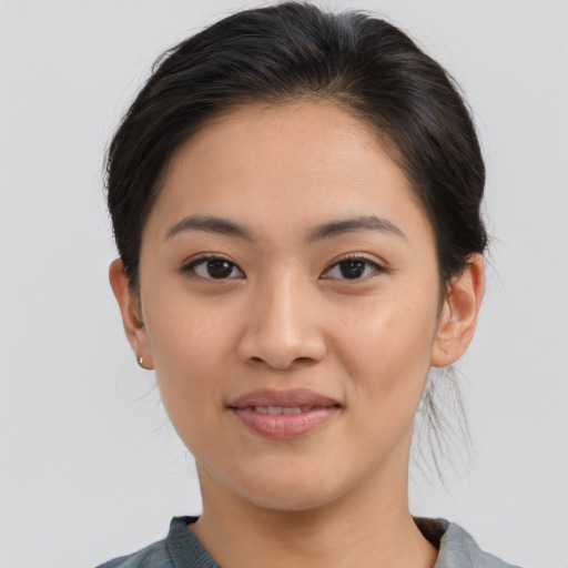 Joyful asian young-adult female with medium  brown hair and brown eyes