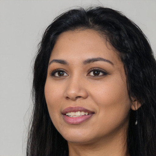 Joyful latino young-adult female with long  black hair and brown eyes