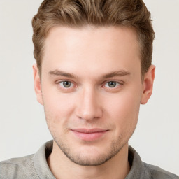 Joyful white young-adult male with short  brown hair and grey eyes