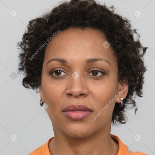 Joyful black adult female with short  brown hair and brown eyes