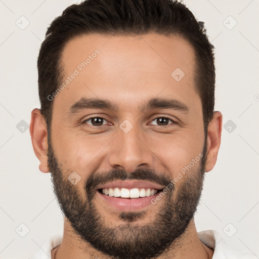 Joyful white young-adult male with short  black hair and brown eyes