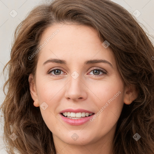 Joyful white young-adult female with long  brown hair and green eyes