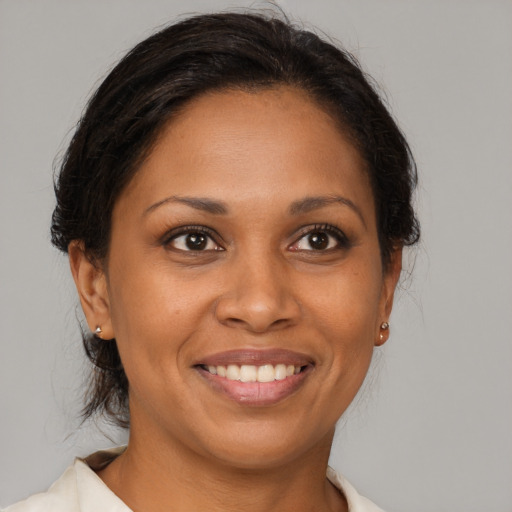 Joyful black young-adult female with medium  brown hair and brown eyes