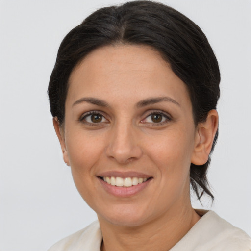 Joyful white adult female with medium  brown hair and brown eyes