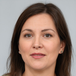 Joyful white adult female with long  brown hair and brown eyes