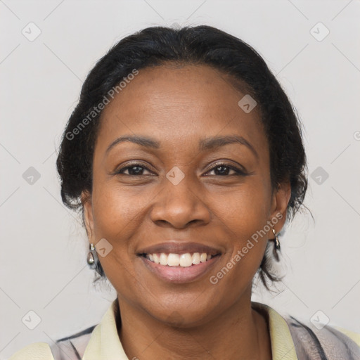 Joyful black adult female with medium  brown hair and brown eyes