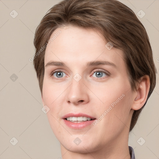 Joyful white young-adult female with short  brown hair and grey eyes