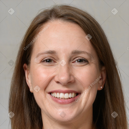 Joyful white adult female with long  brown hair and grey eyes