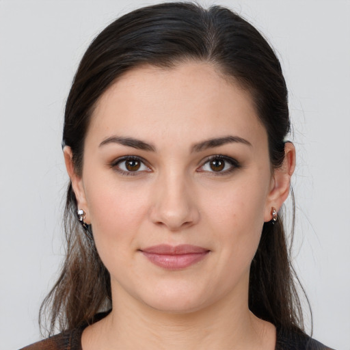 Joyful white young-adult female with long  brown hair and brown eyes