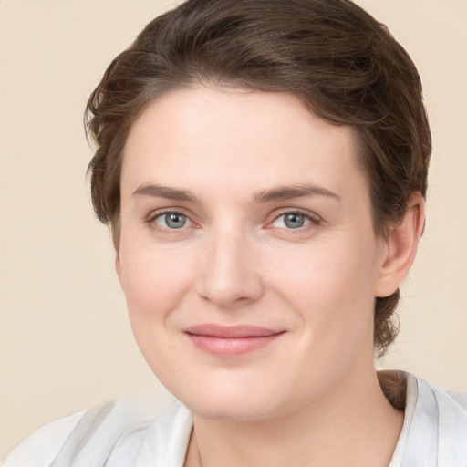 Joyful white young-adult female with medium  brown hair and grey eyes