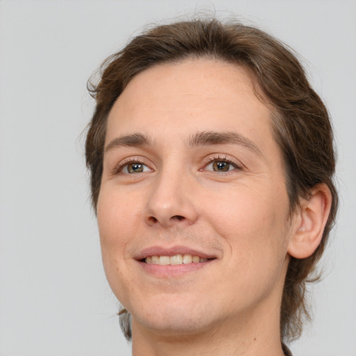 Joyful white young-adult male with medium  brown hair and brown eyes