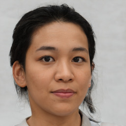 Joyful asian young-adult female with medium  brown hair and brown eyes